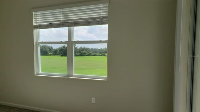 unfurnished room featuring baseboards
