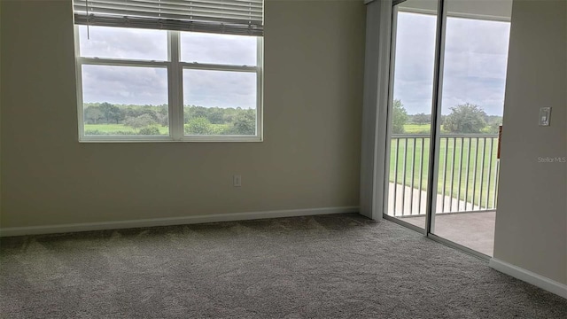 empty room with carpet flooring and baseboards