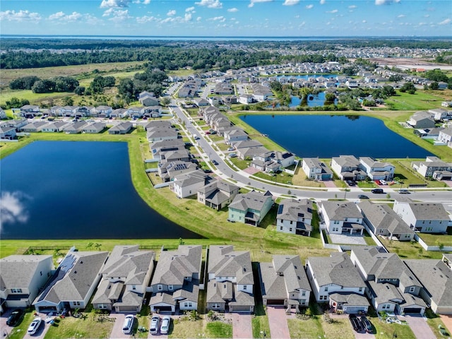 aerial view of residential area featuring a large body of water