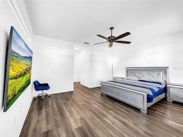 bedroom featuring wood finished floors, baseboards, and ceiling fan