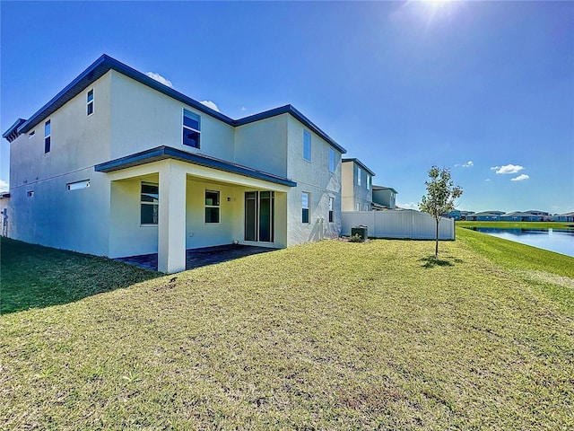 rear view of house featuring a water view, stucco siding, and central air condition unit