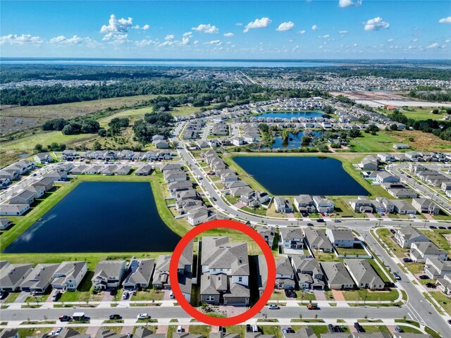 birds eye view of property with a water view and a residential view