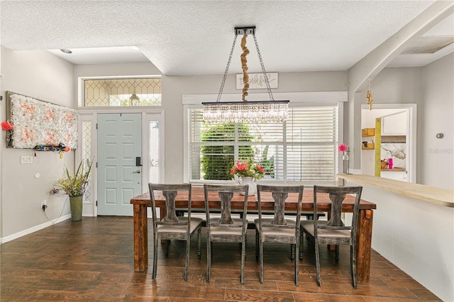 2623 Gables Dr, Eustis, FL 32726 - dining space featuring wood finished floors, a textured ceiling, and baseboards
