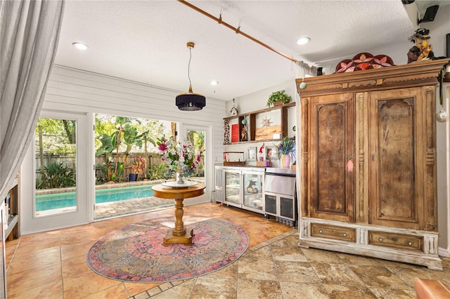 2623 Gables Dr, Eustis, FL 32726 - indoor bar with a textured ceiling, recessed lighting, stone finish floors, wine cooler, and pendant lighting