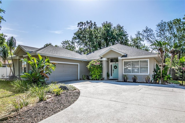 2623 Gables Dr, Eustis, FL 32726 - ranch-style home featuring stucco siding, driveway, an attached garage, and roof with shingles