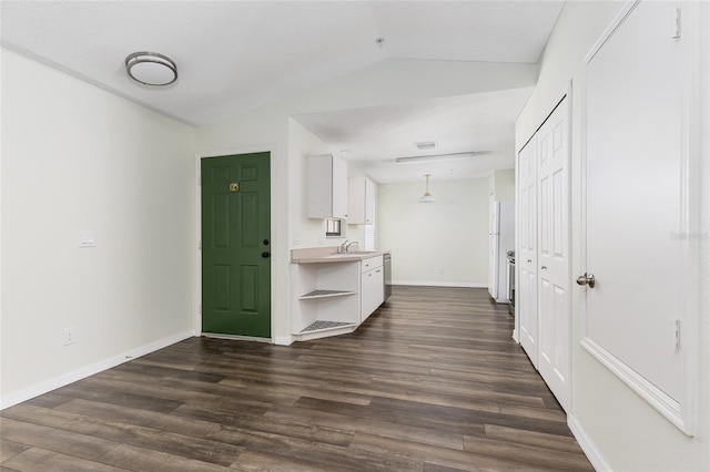 520 Via Verona Ln Unit 202, Altamonte Springs, FL 32714 - interior space with white cabinetry, open shelves, vaulted ceiling, dark wood-style floors, and light countertops