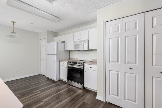 520 Via Verona Ln Unit 202, Altamonte Springs, FL 32714 - kitchen featuring white appliances, dark wood-type flooring, light countertops, white cabinetry, and pendant lighting
