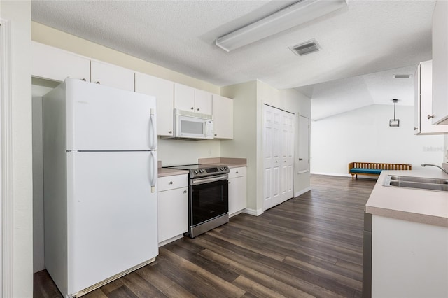 520 Via Verona Ln Unit 202, Altamonte Springs, FL 32714 - kitchen with white appliances, a sink, dark wood finished floors, white cabinets, and light countertops