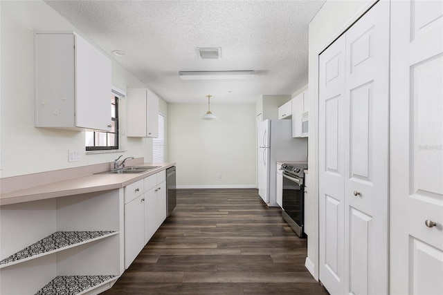 520 Via Verona Ln Unit 202, Altamonte Springs, FL 32714 - kitchen featuring a sink, appliances with stainless steel finishes, white cabinetry, a textured ceiling, and dark wood finished floors