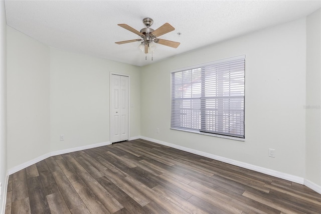 520 Via Verona Ln Unit 202, Altamonte Springs, FL 32714 - spare room featuring dark wood-type flooring, ceiling fan, baseboards, and a textured ceiling