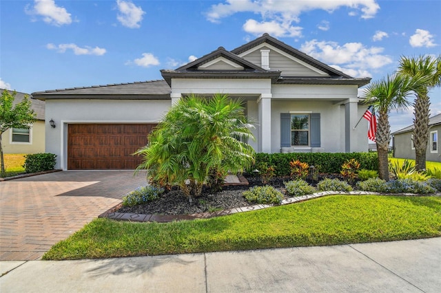 31840 Magna Gulf Loop, San Antonio, FL 33576 - view of front of house with decorative driveway, a garage, and stucco siding