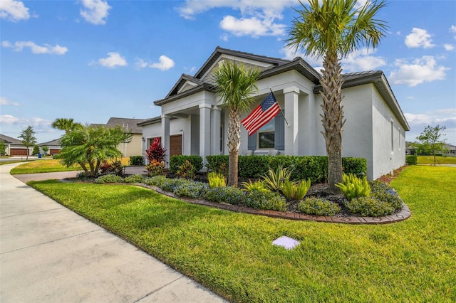 31840 Magna Gulf Loop, San Antonio, FL 33576 - view of property exterior with stucco siding, a garage, a lawn, and driveway