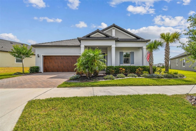 31840 Magna Gulf Loop, San Antonio, FL 33576 - view of front of property featuring decorative driveway, a garage, a front lawn, and stucco siding