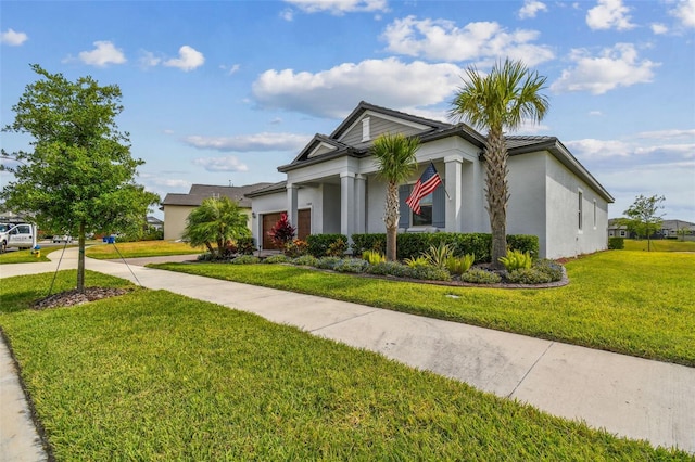 31840 Magna Gulf Loop, San Antonio, FL 33576 - view of front of house featuring stucco siding, a front lawn, a garage, and concrete driveway