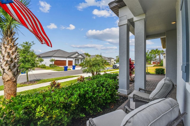 31840 Magna Gulf Loop, San Antonio, FL 33576 - view of patio / terrace with a porch and a residential view