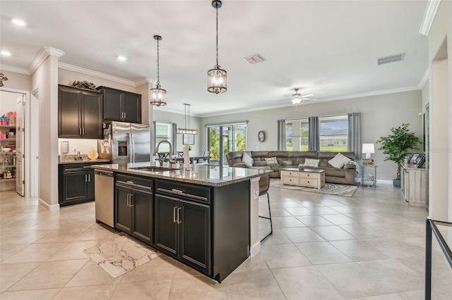 31840 Magna Gulf Loop, San Antonio, FL 33576 - kitchen featuring a sink, stainless steel appliances, ceiling fan, light stone counters, and open floor plan