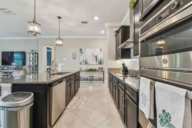 31840 Magna Gulf Loop, San Antonio, FL 33576 - kitchen with appliances with stainless steel finishes, a sink, dark stone counters, ornamental molding, and tasteful backsplash