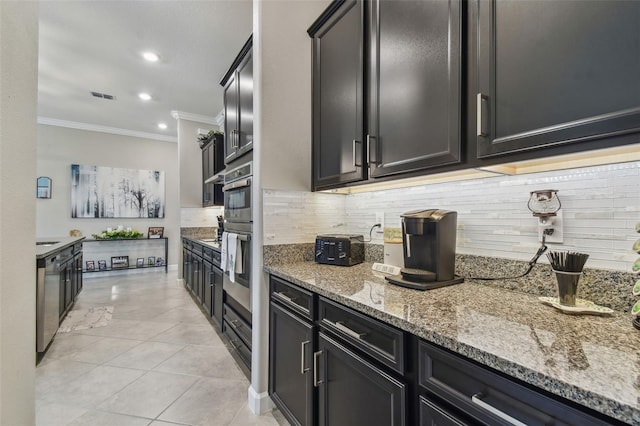 31840 Magna Gulf Loop, San Antonio, FL 33576 - kitchen featuring ornamental molding, dark cabinets, light stone counters, decorative backsplash, and light tile patterned floors