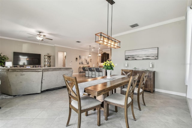 31840 Magna Gulf Loop, San Antonio, FL 33576 - dining room featuring crown molding, ceiling fan, light tile patterned flooring, and baseboards