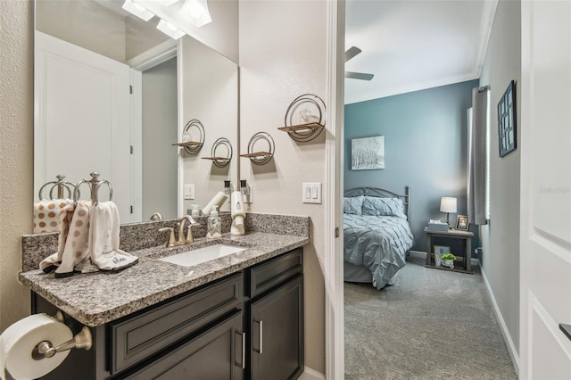 31840 Magna Gulf Loop, San Antonio, FL 33576 - bathroom with ornamental molding, vanity, baseboards, ensuite bathroom, and ceiling fan