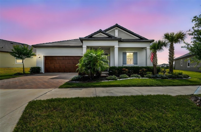 31840 Magna Gulf Loop, San Antonio, FL 33576 - view of front facade with decorative driveway, a garage, a front lawn, and stucco siding