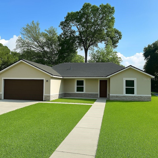 3082 SE 140th Ln, Summerfield, FL 34491 - ranch-style home featuring stone siding, stucco siding, an attached garage, and a front yard