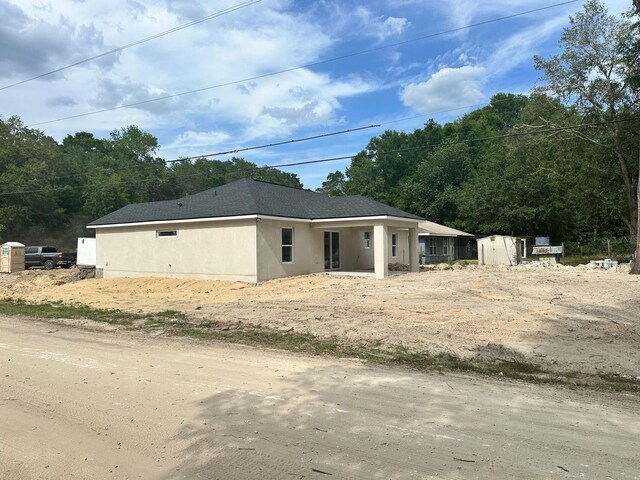 3082 SE 140th Ln, Summerfield, FL 34491 - exterior space featuring stucco siding and a shed