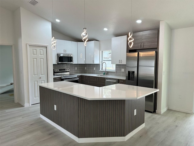 3082 SE 140th Ln, Summerfield, FL 34491 - kitchen with light countertops, light wood-type flooring, stainless steel appliances, and backsplash