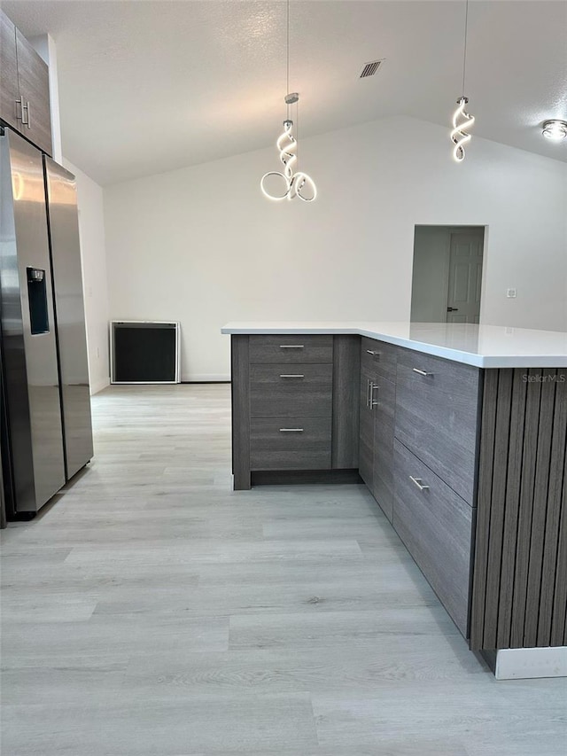 3082 SE 140th Ln, Summerfield, FL 34491 - kitchen with lofted ceiling, gray cabinets, stainless steel refrigerator with ice dispenser, light wood finished floors, and modern cabinets