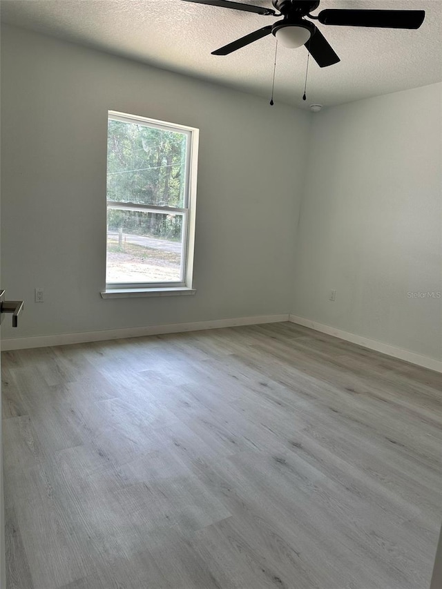 3082 SE 140th Ln, Summerfield, FL 34491 - unfurnished room featuring a ceiling fan, baseboards, a textured ceiling, and wood finished floors