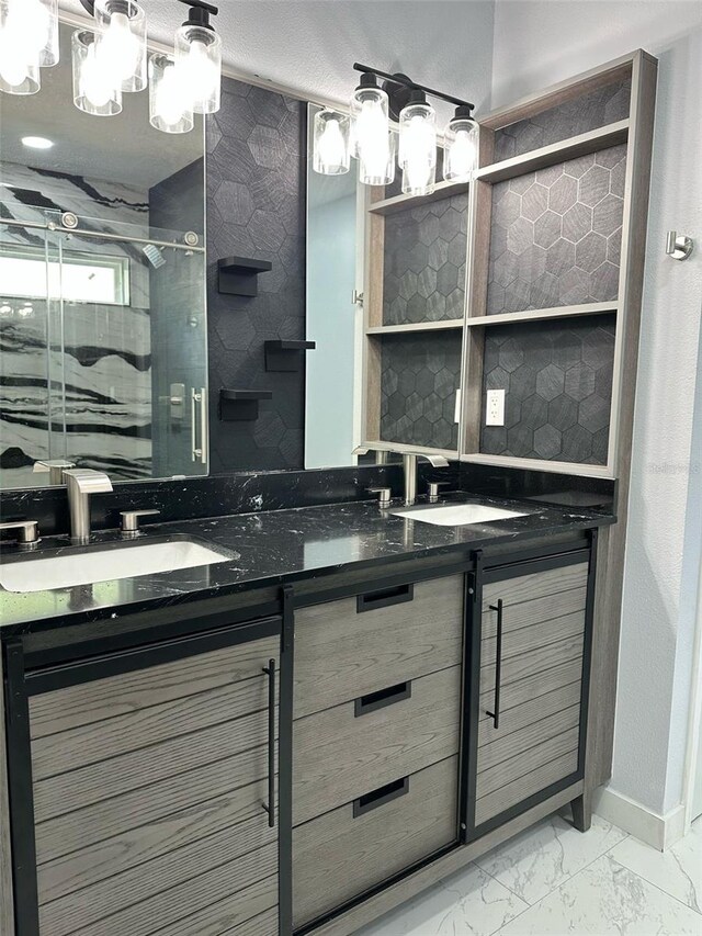 3082 SE 140th Ln, Summerfield, FL 34491 - bathroom featuring double vanity, marble finish floor, a shower stall, and a sink