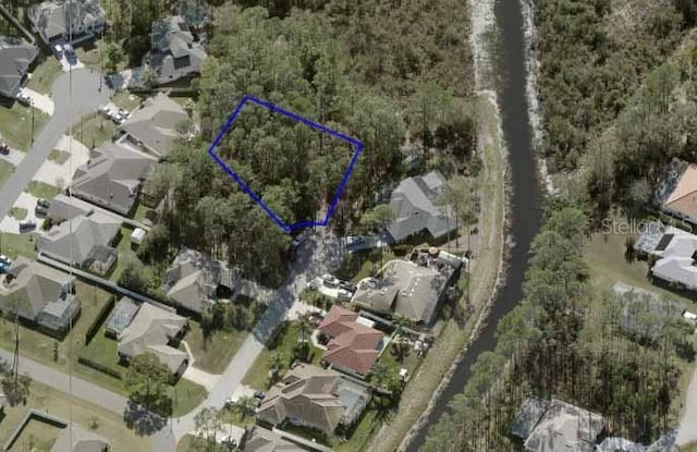 aerial perspective of suburban area with property parcel outlined