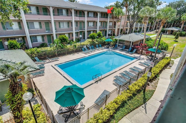 community pool featuring a patio and fence