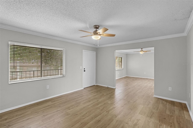 unfurnished room with a ceiling fan, a textured ceiling, wood finished floors, crown molding, and baseboards