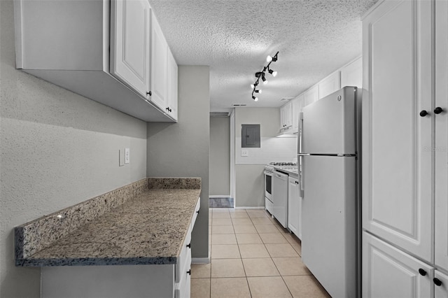 kitchen featuring freestanding refrigerator, range, electric panel, rail lighting, and white cabinets