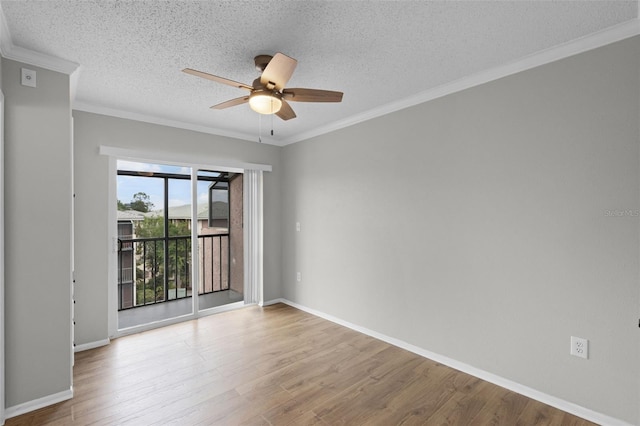 empty room with ceiling fan, wood finished floors, a textured ceiling, baseboards, and ornamental molding