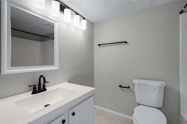 full bathroom with a textured ceiling, tile patterned flooring, toilet, vanity, and baseboards