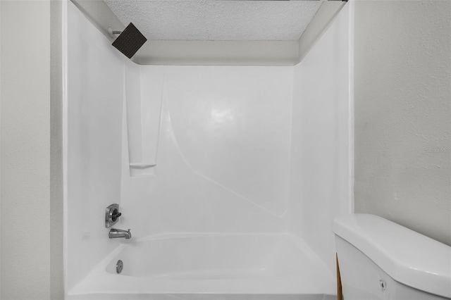 full bath with a textured ceiling, shower / bath combination, and toilet