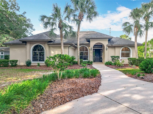 502 Canopy Ln, Lady Lake, FL 32159 - view of front of house with stucco siding and a shingled roof