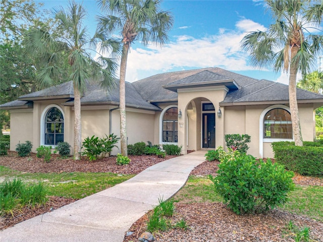 502 Canopy Ln, Lady Lake, FL 32159 - mediterranean / spanish-style house featuring stucco siding and roof with shingles