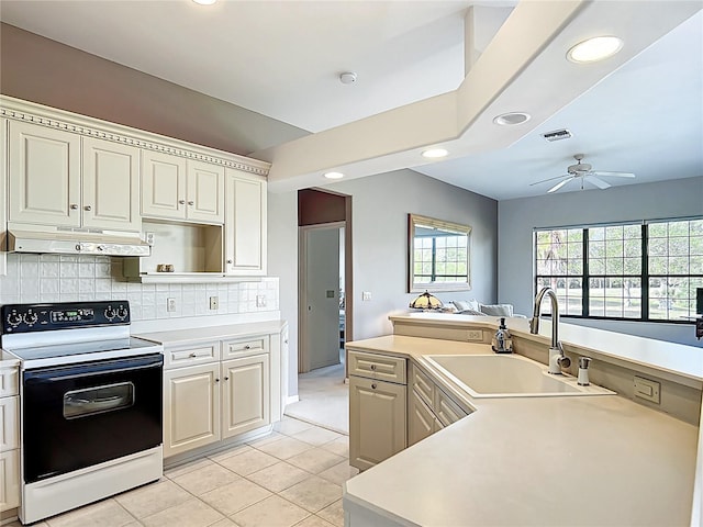 502 Canopy Ln, Lady Lake, FL 32159 - kitchen with electric stove, under cabinet range hood, a ceiling fan, recessed lighting, and light tile patterned flooring