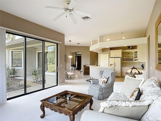 502 Canopy Ln, Lady Lake, FL 32159 - living area featuring a ceiling fan and light carpet
