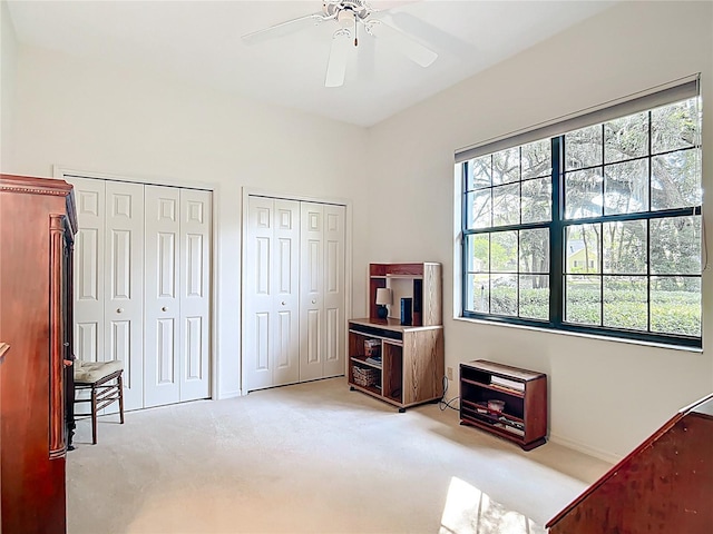 502 Canopy Ln, Lady Lake, FL 32159 - carpeted bedroom featuring two closets and a ceiling fan