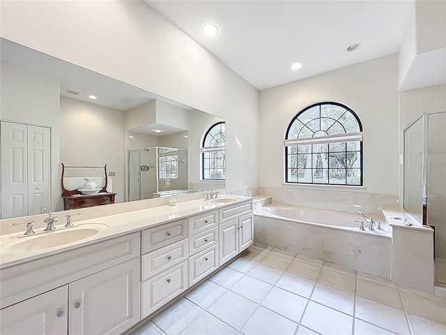 502 Canopy Ln, Lady Lake, FL 32159 - bathroom with a garden tub, a stall shower, double vanity, recessed lighting, and tile patterned flooring