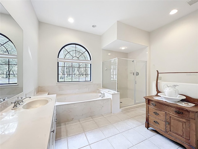 502 Canopy Ln, Lady Lake, FL 32159 - bathroom with vanity, a garden tub, a shower stall, tile patterned floors, and recessed lighting