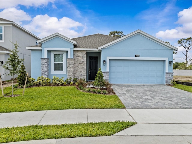 8018 Colby Cir, Orlando, FL 32817 - ranch-style house with stucco siding, stone siding, a front lawn, and a garage