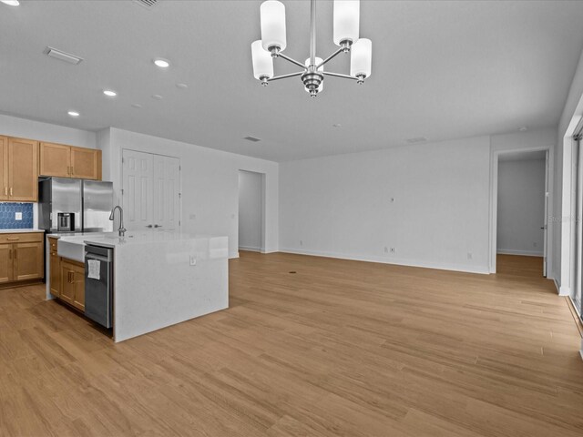 8018 Colby Cir, Orlando, FL 32817 - kitchen featuring dishwasher, a chandelier, stainless steel fridge with ice dispenser, light countertops, and light wood finished floors