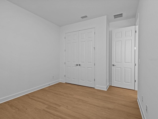 8018 Colby Cir, Orlando, FL 32817 - unfurnished bedroom with baseboards and light wood-type flooring