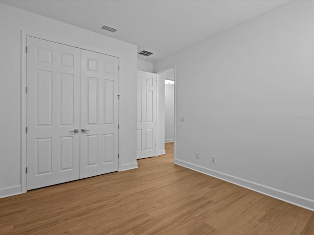 8018 Colby Cir, Orlando, FL 32817 - unfurnished bedroom with light wood-style floors, baseboards, and a closet