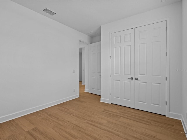 8018 Colby Cir, Orlando, FL 32817 - unfurnished bedroom featuring light wood-type flooring, baseboards, and a closet